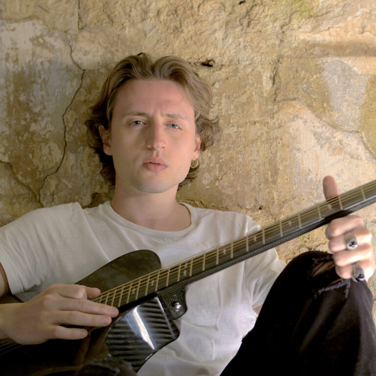 With the acoustic guitar — Break the Distance set